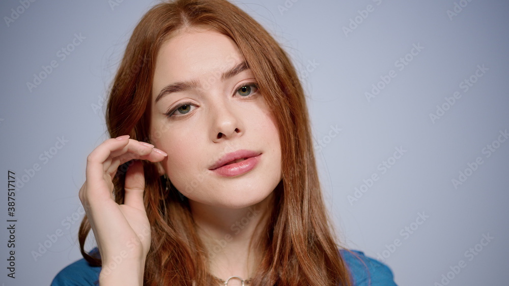 Pretty girl flirting in studio in slow motion. Woman touching face indoors Pretty girl flirting in studio in slow motion. Woman touching face indoors