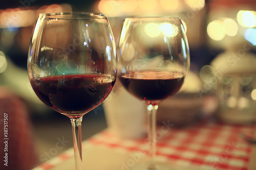 abstract aperitif alcohol glass in a restaurant interior, red wine background