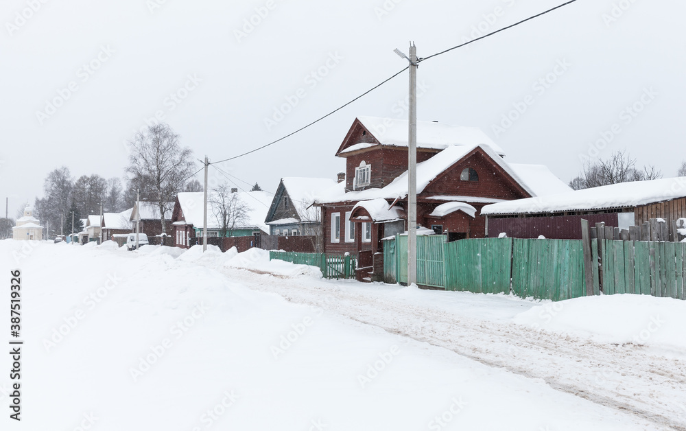 Rural Russian street at snowy winter day. Tikhvin