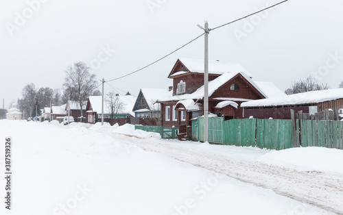 Rural Russian street at snowy winter day. Tikhvin © evannovostro