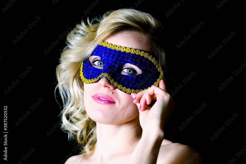 Woman in blue eye mask with bare shoulders,.