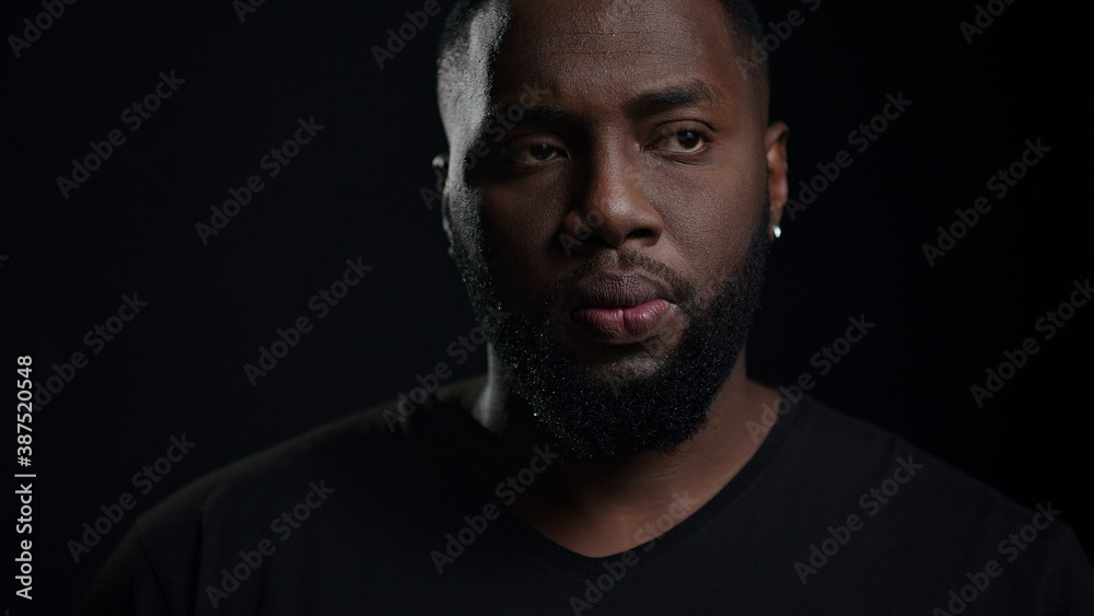 African american man getting an idea indoors. Dreamy man posing in studio