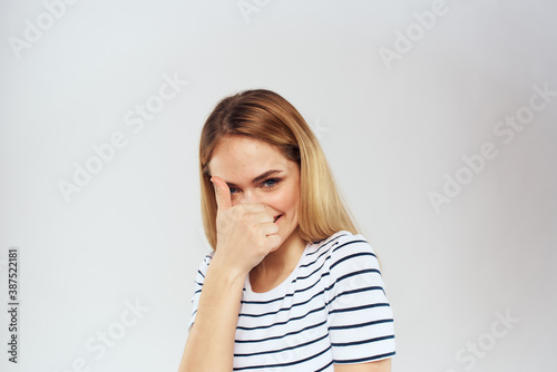 emotional woman in striped t-shirt gesture with hands lifestyle light background