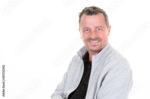 Portrait of handsome smiling young man smiling joyful cheerful in studio shot isolated on white background © OceanProd