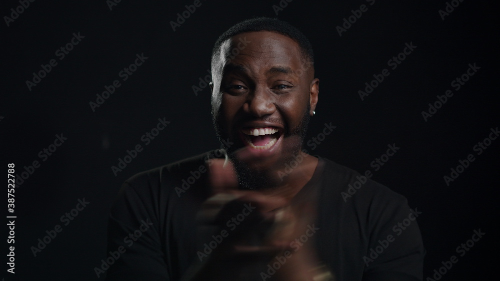 Winner afro guy clapping hands indoors. African man celebrating victory Winner afro guy clapping hands indoors. African man celebrating victory