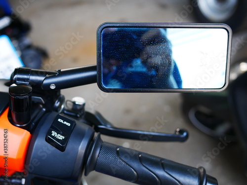 closeup of motorcycle rear view mirror with blank screen.
