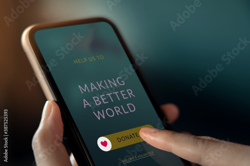 Online Donation, Volunteer and Charity Concept. Woman Making Donate via Internet on Mobile Phone. Closeup