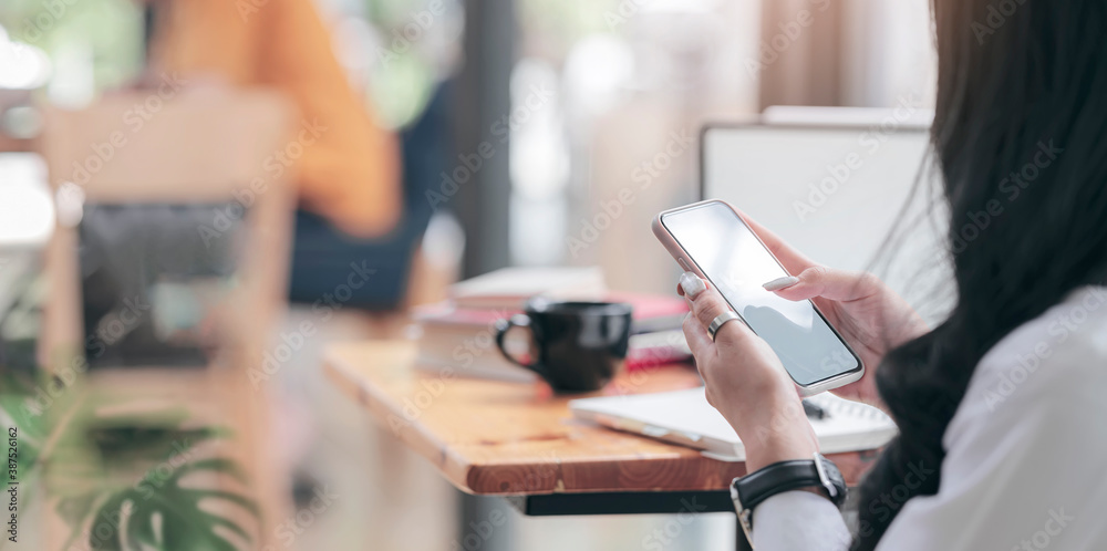 Closeup image of woman hands using smartphone while sitting at cafe, copy space. Closeup image of woman hands using smartphone while sitting at cafe, copy space.