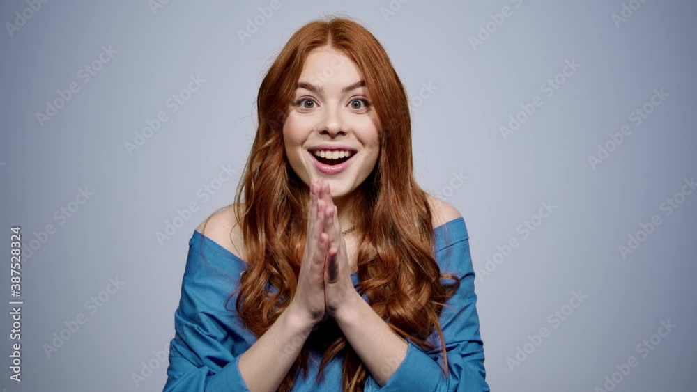 Surprised woman opening mouth on gray background. Cute girl posing in studio Surprised woman opening mouth on gray background. Cute girl posing in studio