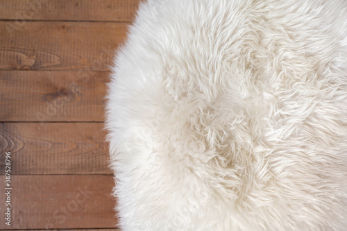 Rough wood floor and white fur rug. New Year or Christmas background. Greeting card.