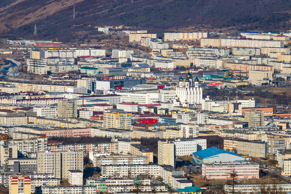 Fototapeta premium Aerial view of the city of Magadan. Top view of the streets, buildings and the cathedral. Large northern Russian city. Magadan, Magadan region, Siberia, Far East of Russia.