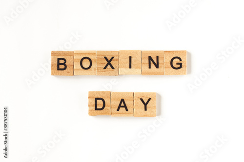 Top view of the words Boxing Day lined from square wooden tiles on white background. Photo for online online stores for the day of discounts during the holidays