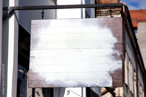 signboard made of old boards, sprinkled with flour, copy space