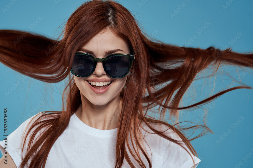 Pretty woman in sunglasses charm long hair white t-shirt blue background