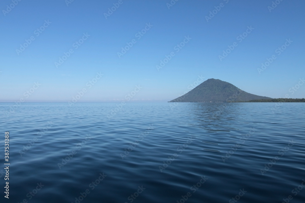 Blue sea and Manadotua island on a horizon. Bunaken marine park, North Sulawesi, Indonesia