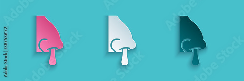 Paper cut Runny nose icon isolated on blue background. Rhinitis symptoms, treatment. Nose and sneezing. Nasal diseases. Paper art style. Vector.
