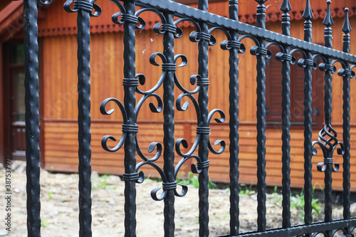 Details of iron fence by the wooden hut.