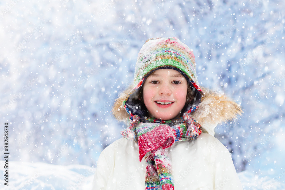Child playing with snow in winter. Kids outdoors. Child playing with snow in winter. Kids outdoors.