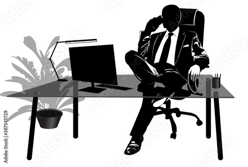 Silhouette of businessman talking on the phone at his desk