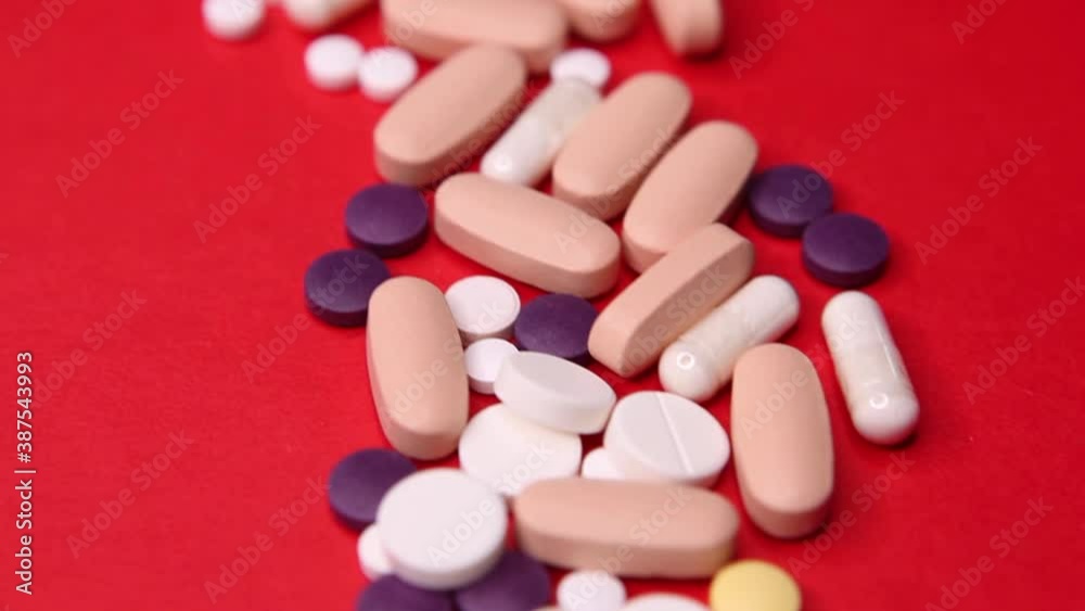 Various pills macro on red background. Top view Various pills macro on red background. Top view