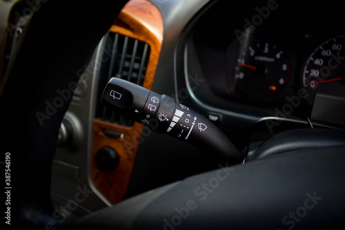 Windscreen wiper control switch in car. Wipers control. Modern car interior detail. adjusting speed of screen wipers in car. © Muanpare