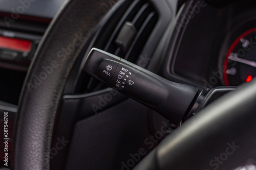 Windscreen wiper control switch in car. Wipers control. Modern car interior detail. adjusting speed of screen wipers in car. © Muanpare