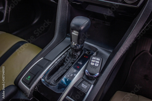 automatic transmission shift selector in the car interior. Closeup a manual shift of modern car gear shifter. © Muanpare