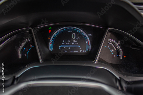 Car​ dashboard​ modern​ automobile control​ illuminated panel​ speed display.