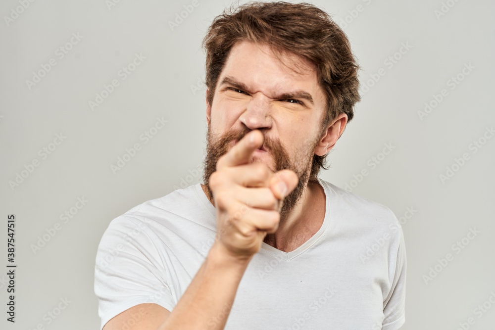 Fototapeta premium man in white t-shirt emotions expressions gesture with hands cropped view light background