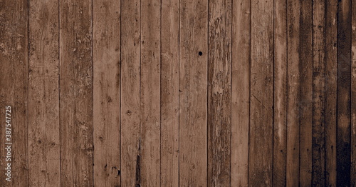 Wooden natural background with light sepia art processing.Fragment of old wooden wall cladding.