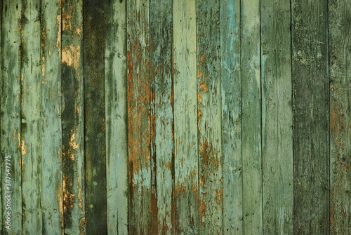 Wooden natural background with art processing. Fragment of old wooden wall cladding.