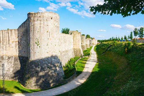 Medieval city wall reinforced with massive round tower and a deep moat. Provins, Seine-et-Marne, France.
