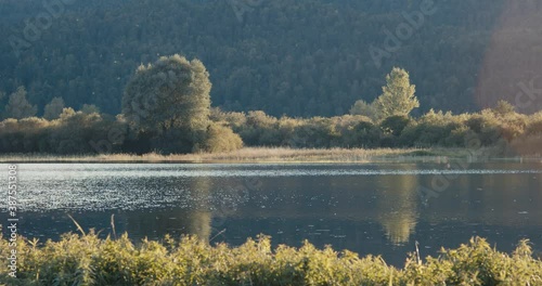 Autumn evening on intermittent lake Cerknica light flare in Slovenia