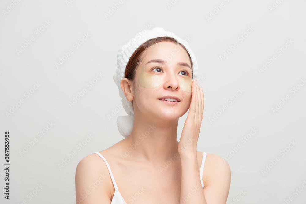 A woman caring for her face with patches A woman caring for her face with patches