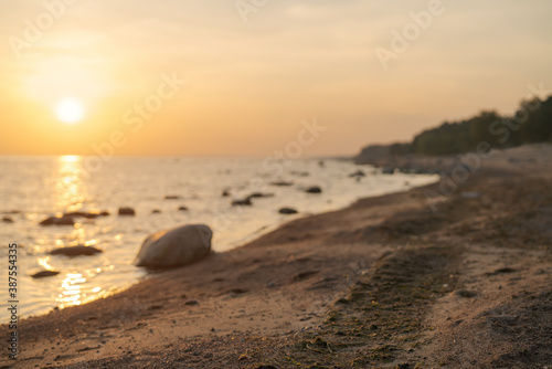 Fototapeta Naklejka Na Ścianę i Meble -  Sunset on baltic sea beach with rocks in sand