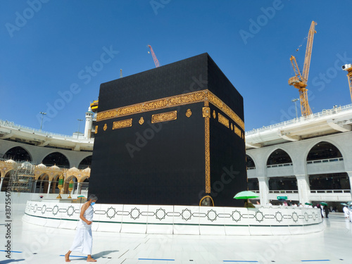 MECCA, SAUDI ARABIA , OCTOBER 22, 2020 - The Holy Kaaba - Pilgrims return to Mecca for limited umrah as  coronavirus restrictions - face mask wearing Muslims perform umrah  in Makka photo