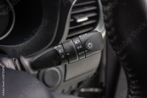 Switch off lights in a car. close-up Car integrated turning indicator with headlight switch toggle.