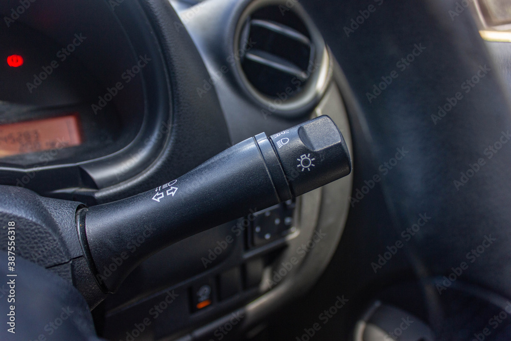 Switch off lights in a car. close-up Car integrated turning indicator with headlight switch toggle.