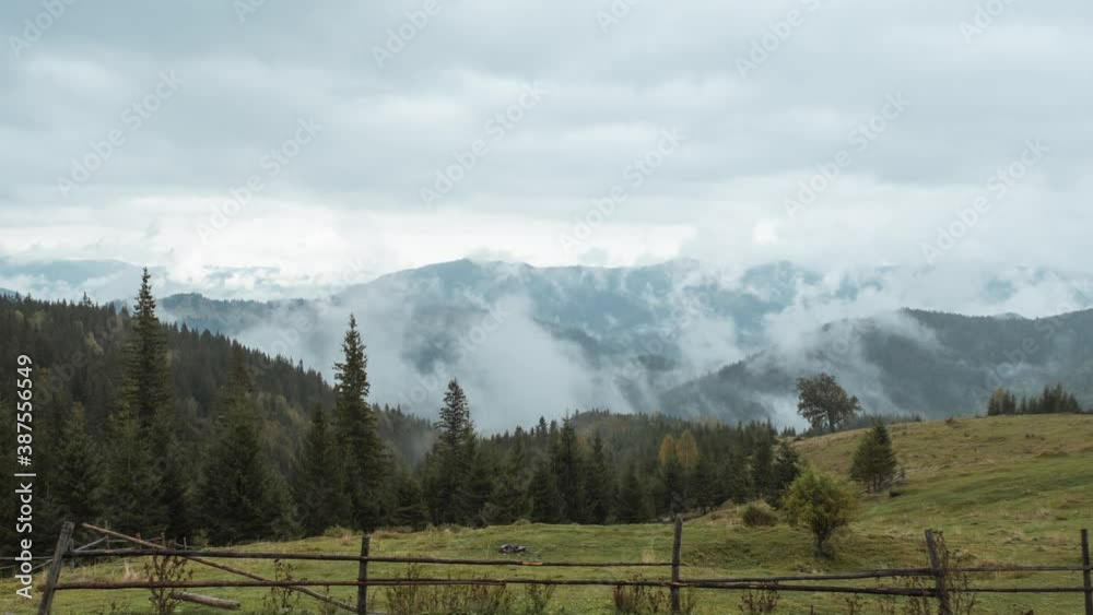 Moody and mysterious time lapse of coniferous forest with mist and fog - Firs, pine trees, mountains. Autumn look. Carpathian mountains, Ukraine.
Forest landscape with cloud and fog in timelapse. Moody and mysterious time lapse of coniferous forest with mist and fog - Firs, pine trees, mountains. Autumn look. Carpathian mountains, Ukraine.
Forest landscape with cloud and fog in timelapse.