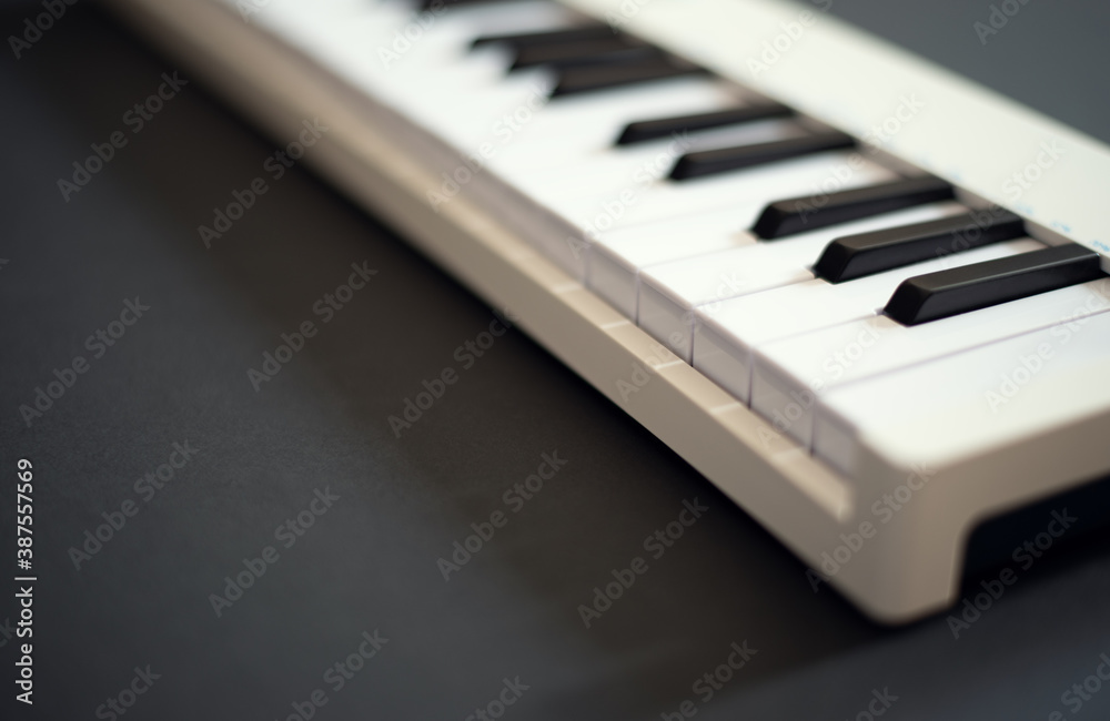 Midi piano keyboard for playing digital music & making remixes.Audio equipment for professional sound recording studio.Focus on piano keys Midi piano keyboard for playing digital music & making remixes.Audio equipment for professional sound recording studio.Focus on piano keys