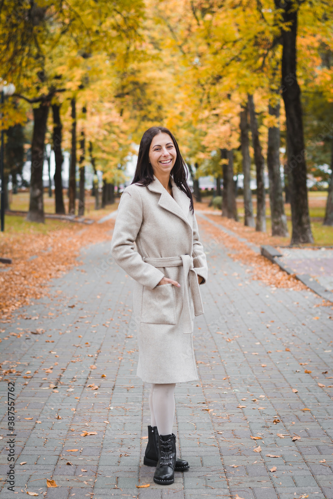 elegant brunette girl on footpath in city park elegant brunette girl on footpath in city park