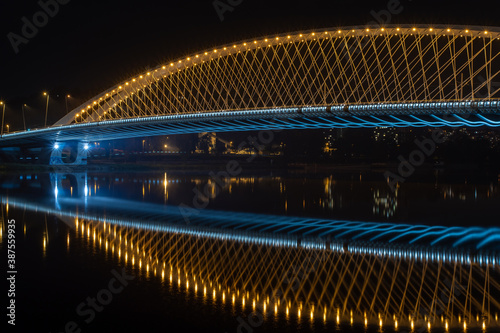 lighting traffic bridge over the Vltava river in the center of Prague at night in the Czech Republic on October 22