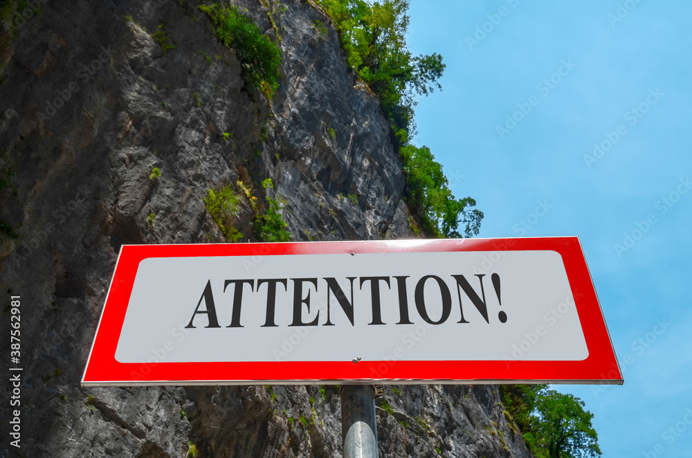 Warning sign Attention in the mountains. Tablet with inscription