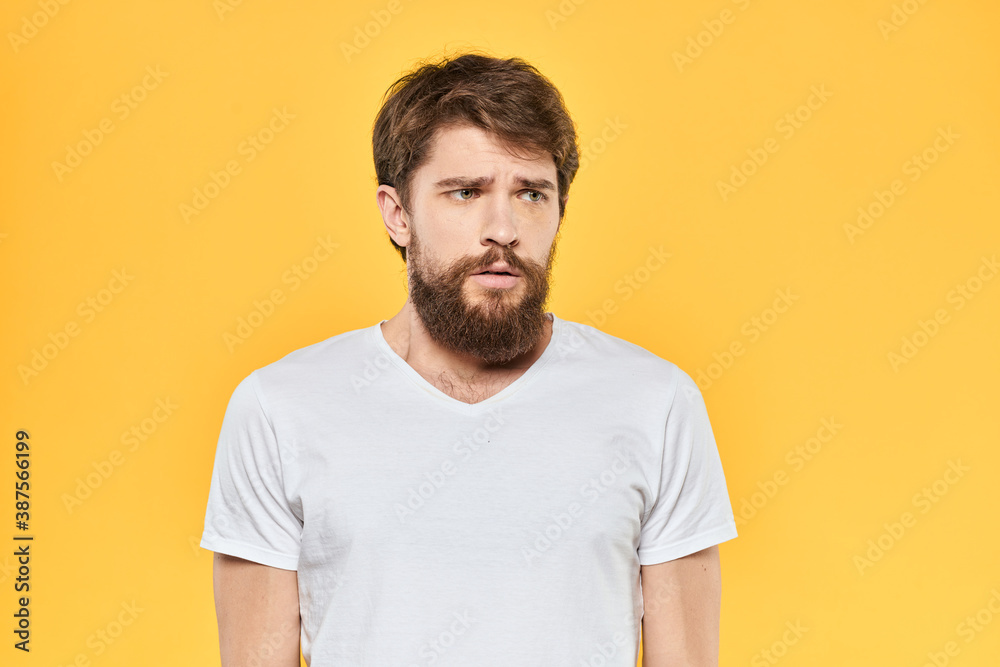 Fototapeta premium Bearded man emotions gestures with hands facial expression white t-shirt yellow background