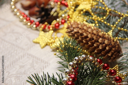 Fir branches, cones and Christmas decorations on a gray background