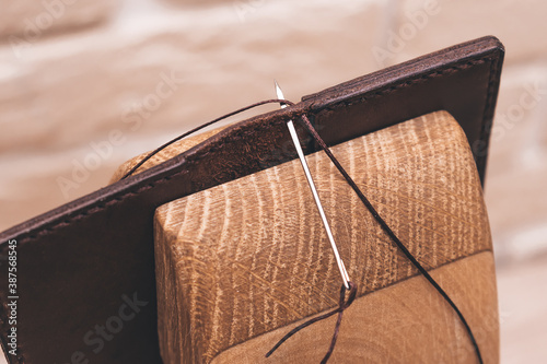 Product made of genuine leather in the process of stitching close-up. Leather business photo