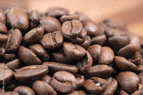 fresh coffee beans on wooden background 