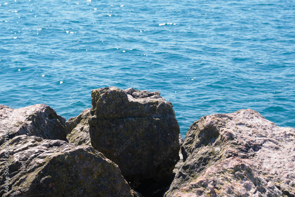 Large brown stones on the background of water Large brown stones on the background of water