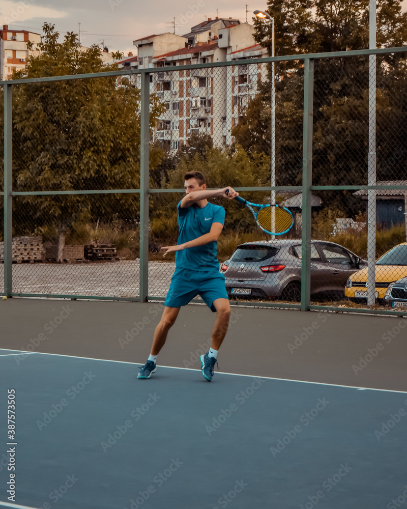 Young man playing tennis.