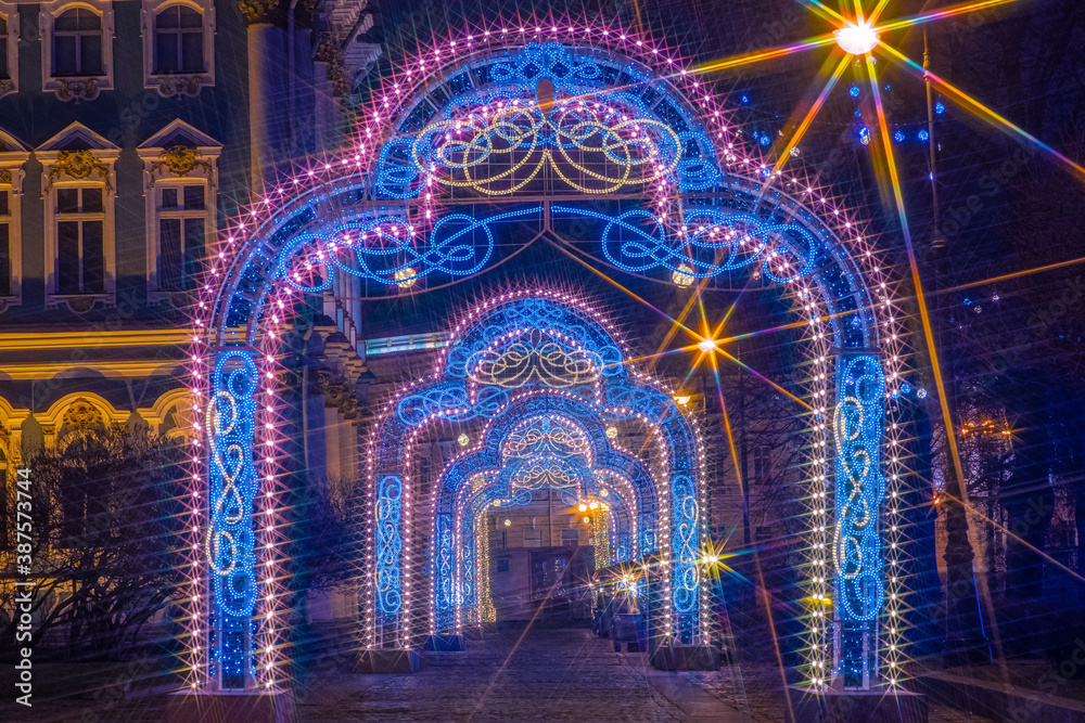 Fototapeta premium Saint Petersburg on Christmas night. Russia in winter. Christmas arches in Saint Petersburg. Glowing arches in Russian city. Lights of Christmas Petersburg. Celebrating the new year in Russia.